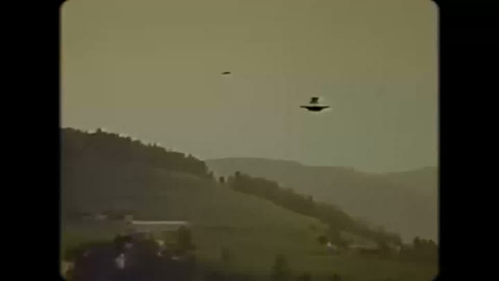 Two dark forms above a valley